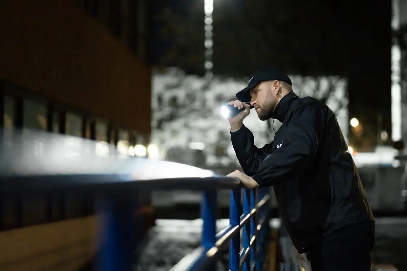 Security officer on night patrol with a flashlight