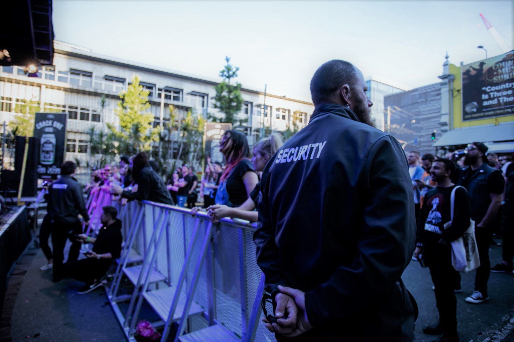 ANSIC security officers in SECURITY jackets on post at an outdoor event